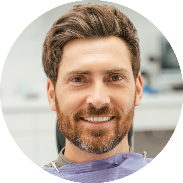 smiling bearded man sitting in dental chair